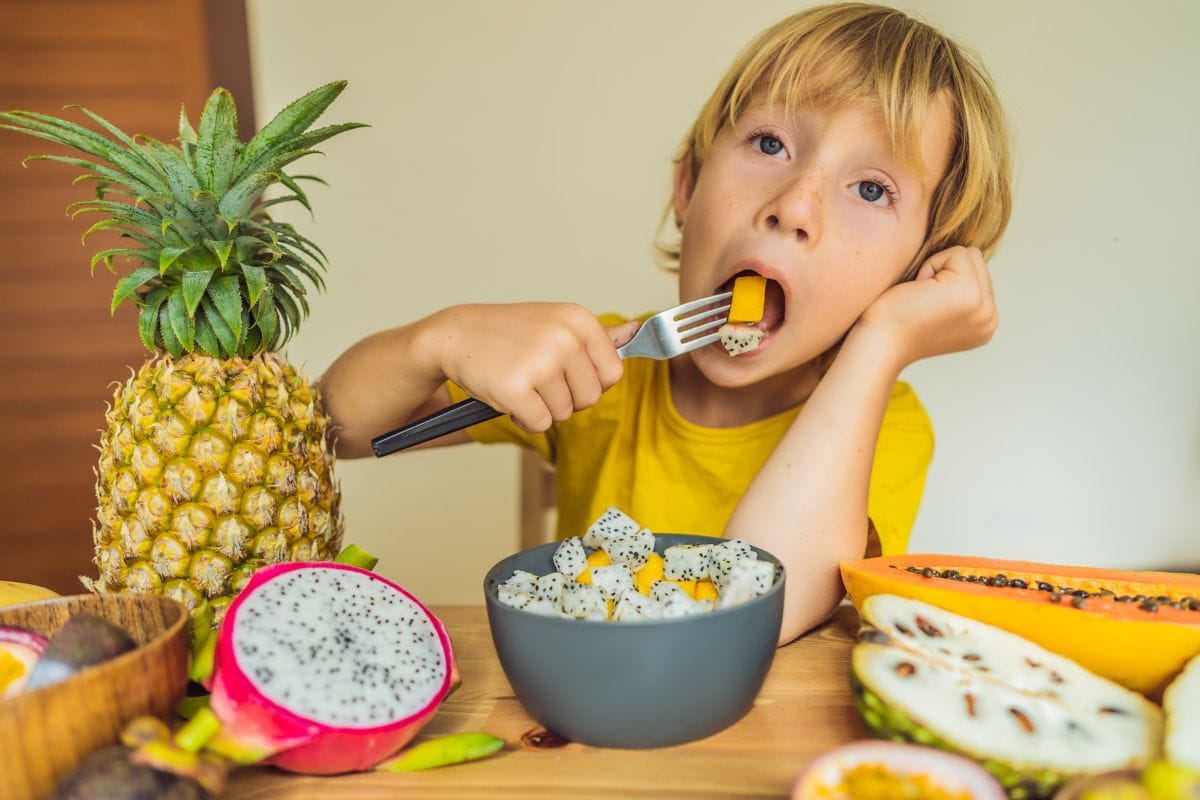 boy eating nutrient-rich fruits