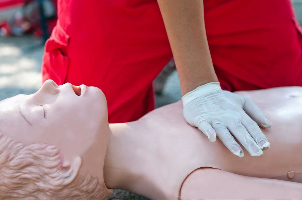 chest compressions on a CPR training child mannequin chest compressions on a CPR training child mannequin